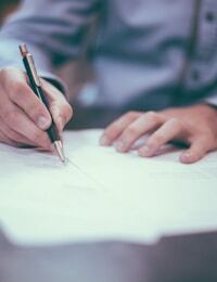Laptop and documents on a desk — financial worksheets and planning