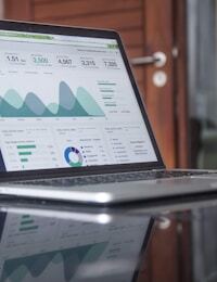 Laptop showing charts and metrics — long-term index investing